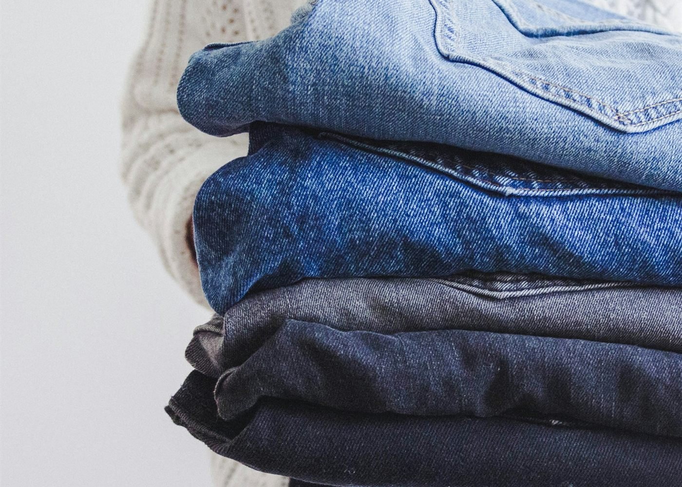 Clean, neatly folded clothes being carried back to a customer