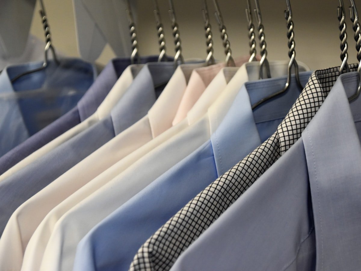 Dry-cleaned shirts hanging pressed and covered