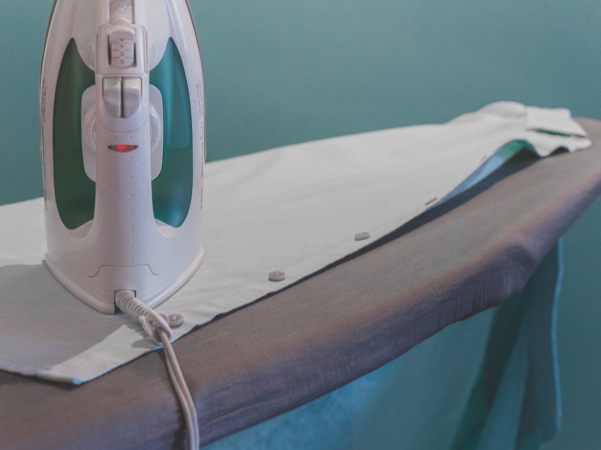 A steam iron pressing a freshly washed shirt